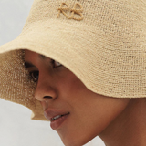 KABE SHOP INC beige woven bucket hat with embroidered monogram detail worn by a model