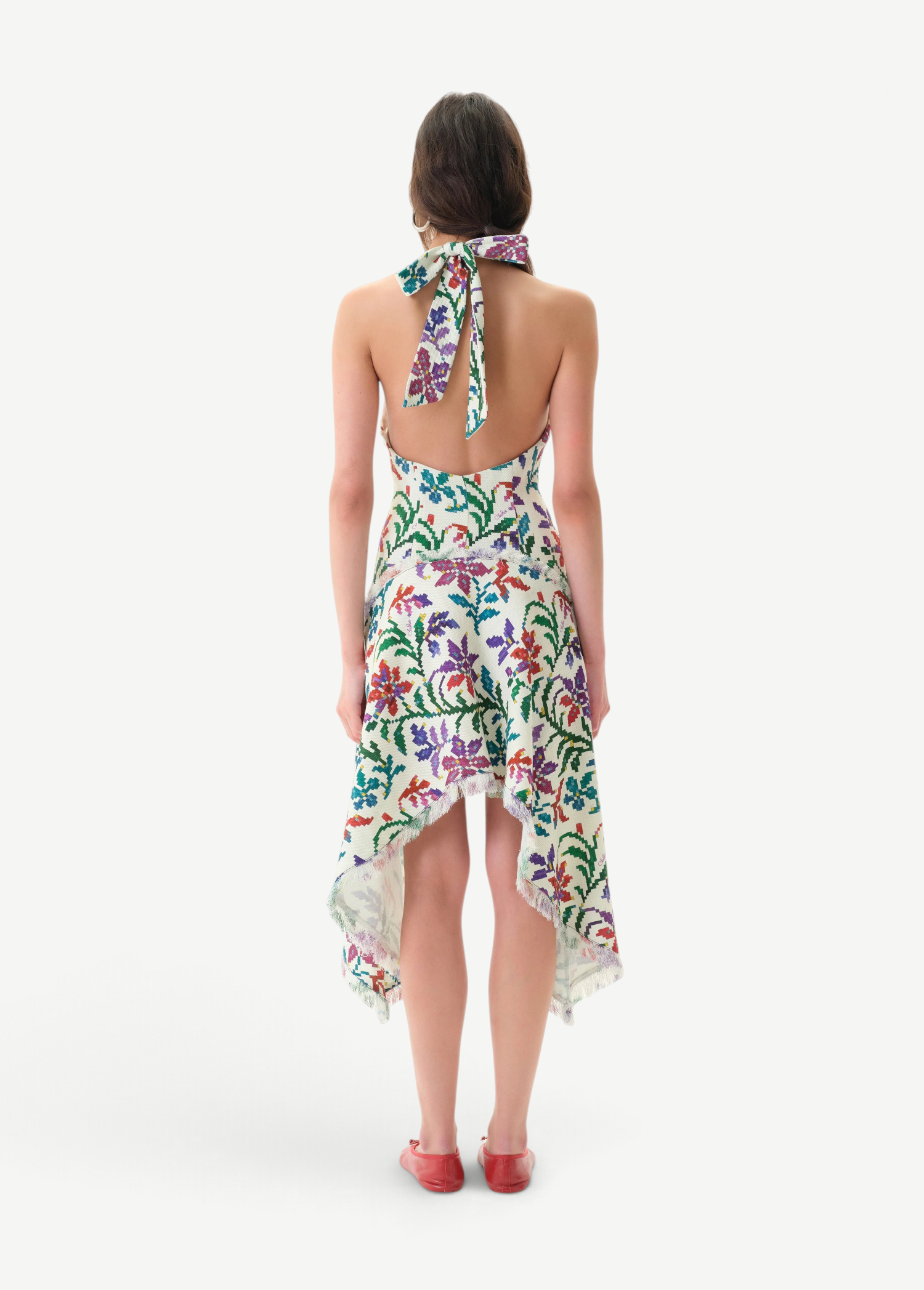Back view of KABE SHOP INC Belora cotton dress with floral print, halter neck, and raw-edge asymmetric hemline.