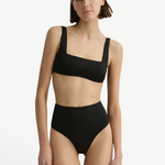 Model wearing KABE SHOP INC Poppy high-waisted black bikini bottom with a matching square-neck bikini top