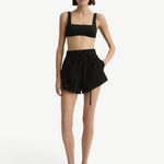 Model wearing KABE SHOP INC black Kyoto Short in Japanese dry cotton with an elastic waist and removable tie belt.