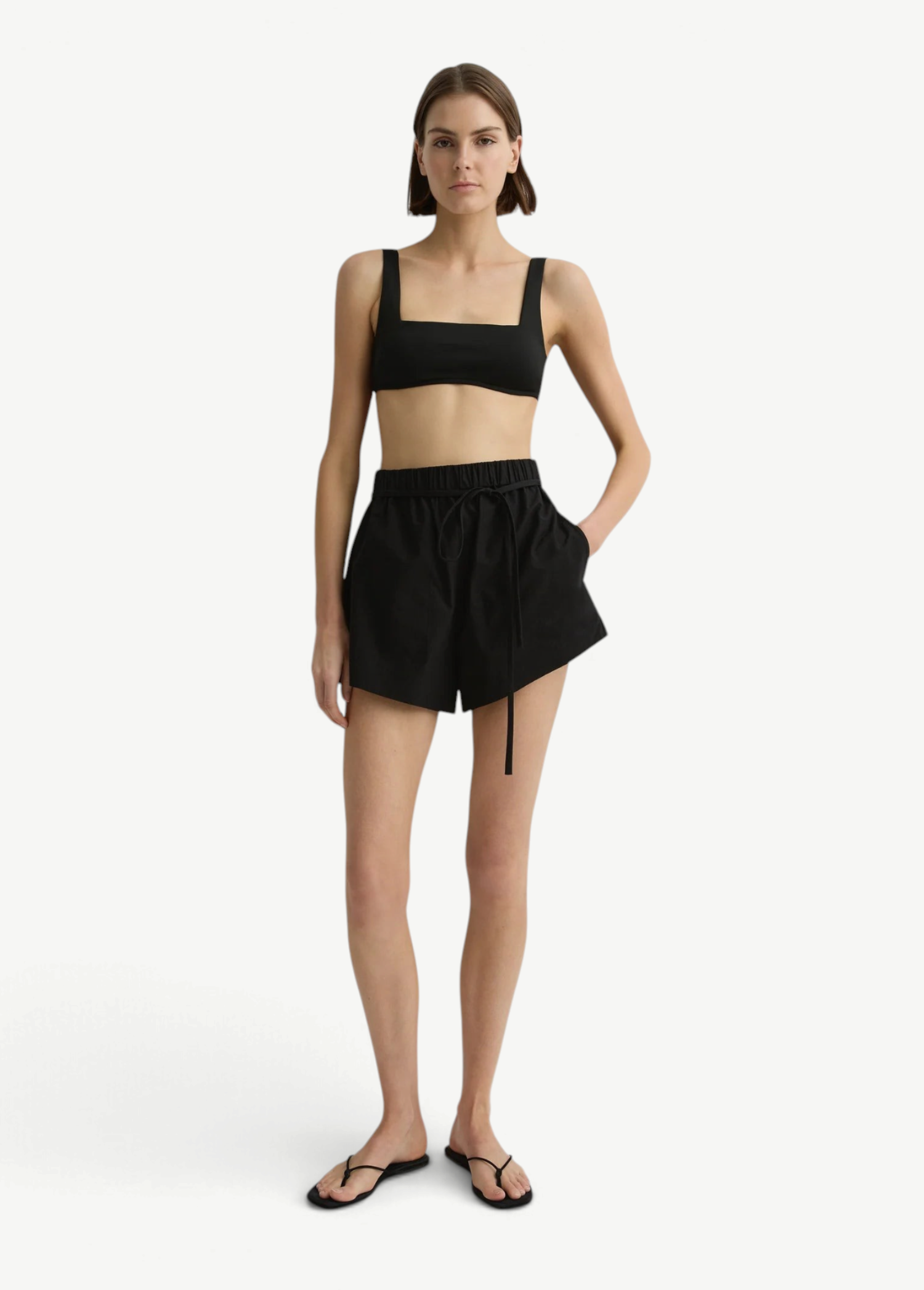 Model wearing KABE SHOP INC black Kyoto Short in Japanese dry cotton with an elastic waist and removable tie belt.