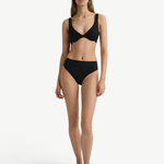 Model wearing a black KABE SHOP INC Gracie bikini top and matching high-waisted bottoms against a white background.