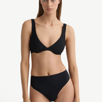Model wearing KABE SHOP INC Gracie black bikini top with a supportive silhouette and clean lines