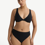 Model wearing KABE SHOP INC Gracie black bikini top with a supportive silhouette and clean lines