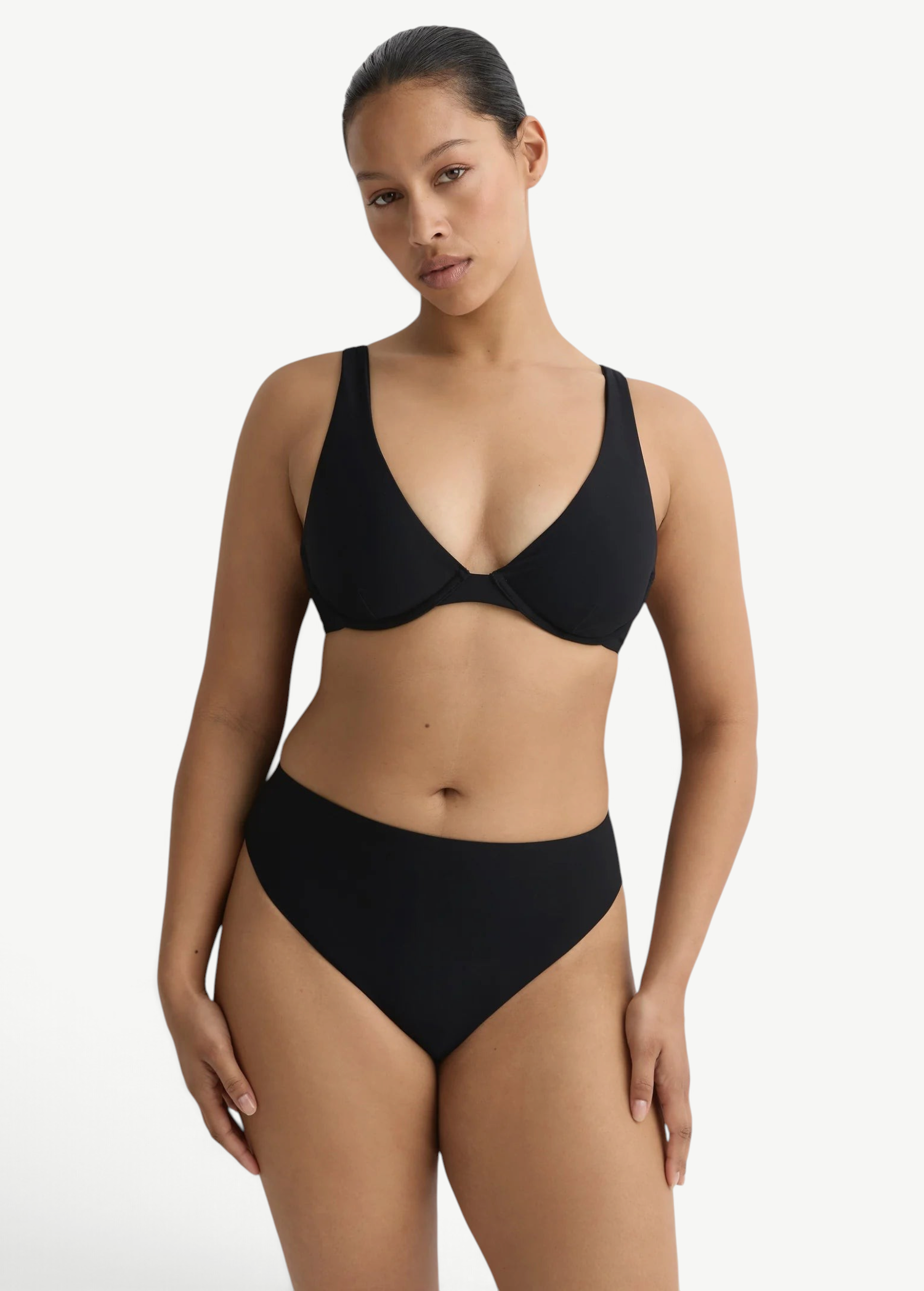 Model wearing KABE SHOP INC Gracie black bikini top with a supportive silhouette and clean lines