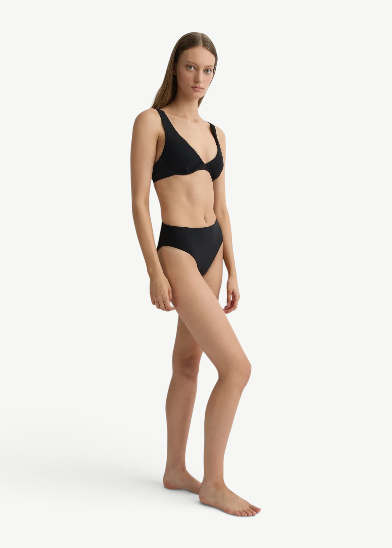 Model wearing KABE SHOP INC Gracie black bikini top with a supportive silhouette and matching high-waisted bottoms.