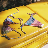 KABE SHOP INC Marseille paisley print bikini set with tie-side bottoms and gold hardware on yellow sun loungers