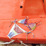 KABE SHOP INC Marseille Lizzy tie-side bikini set in a vibrant paisley print with earthy and bright tones.