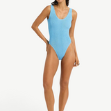 KABE SHOP INC Mara one-piece swimsuit in light blue textured fabric with a V-neck and high-cut leg on a model