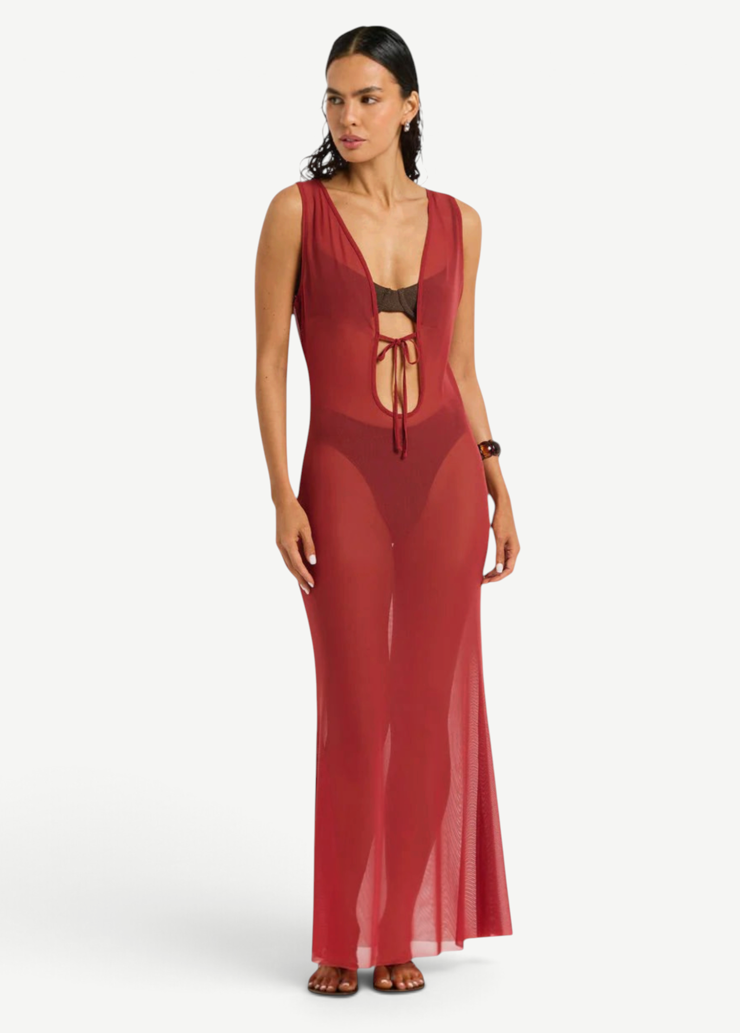 Model wearing a KABE SHOP INC Harper red sheer mesh maxi dress with a front tie detail over a dark bikini