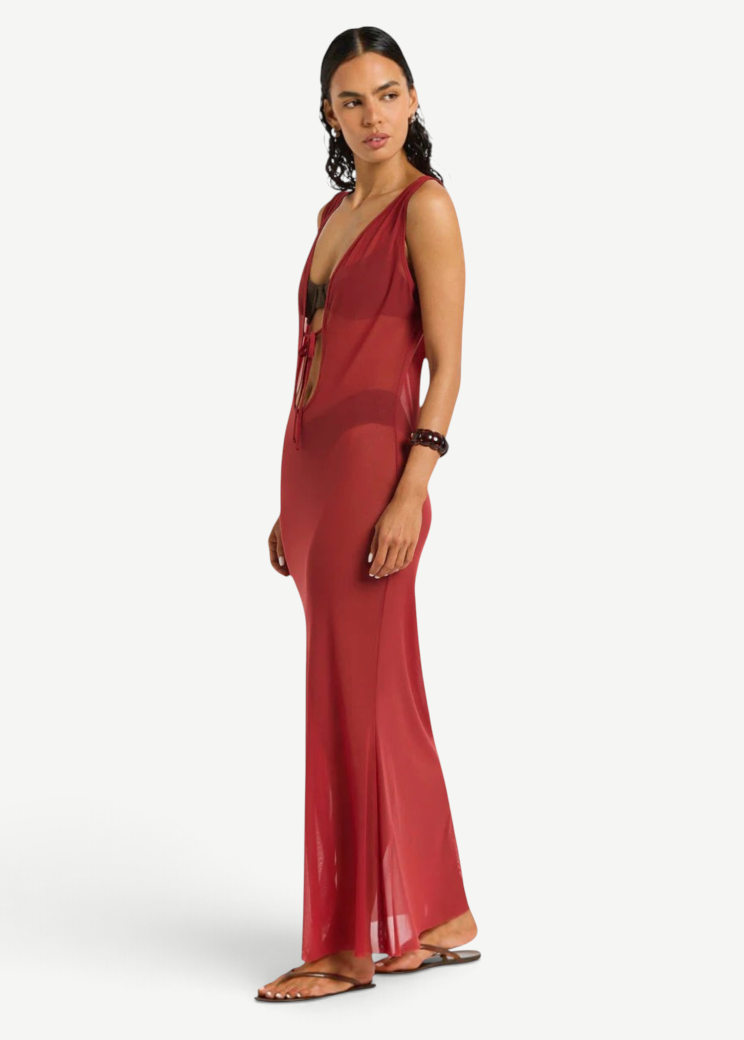 KABE SHOP INC Harper maxi dress in sheer red mesh with a deep V-neck and tie front, worn by a model over swimwear.