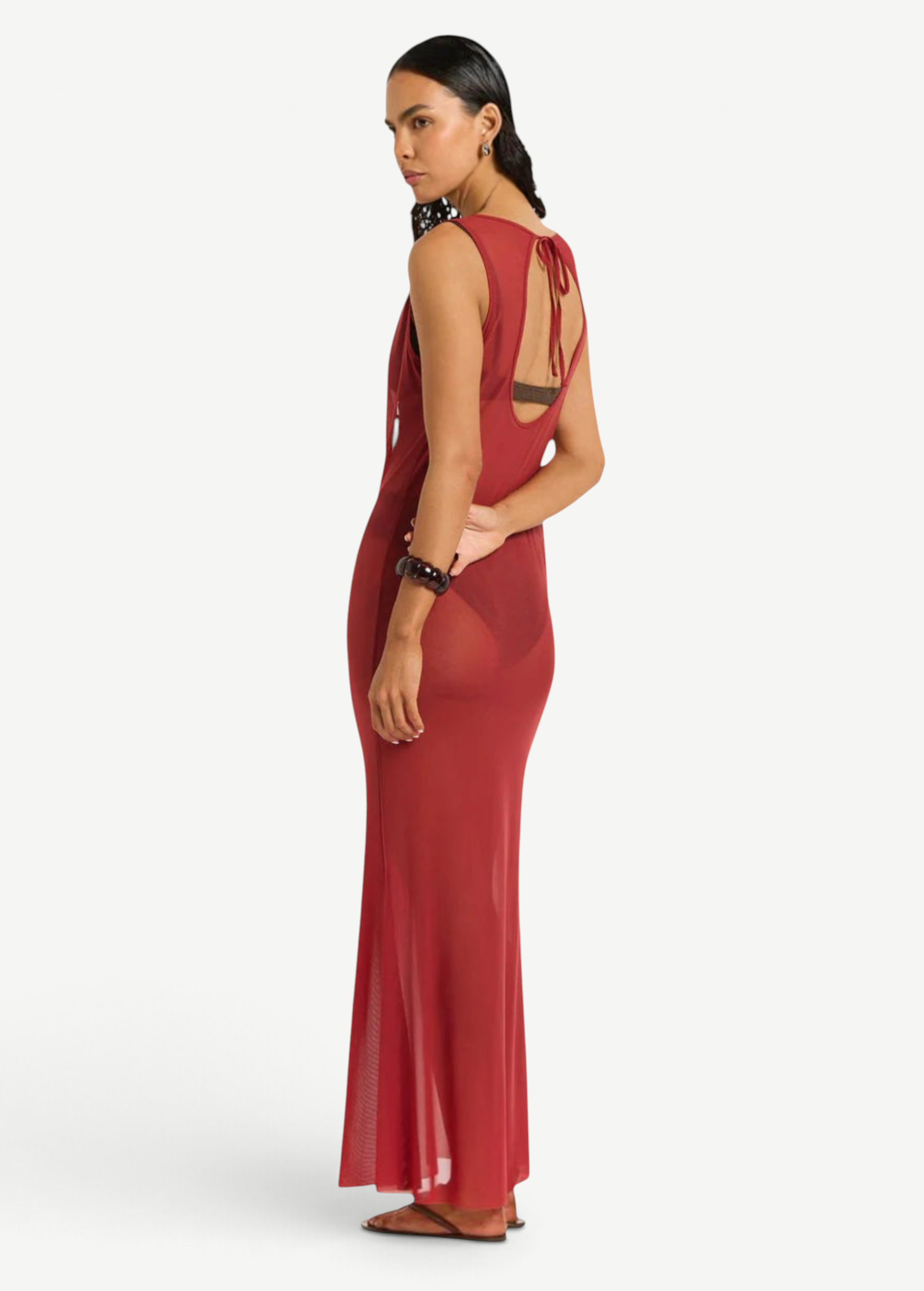 KABE SHOP INC Harper maxi dress in sheer red mesh with a tie-back detail, worn by a model against a white background.