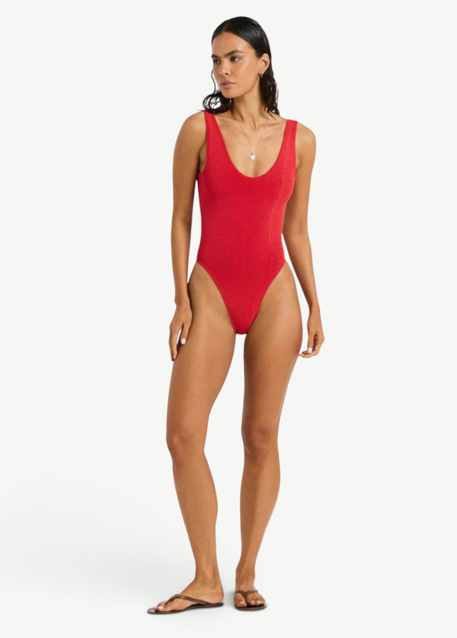 Model wearing KABE SHOP INC Mara red one-piece swimsuit with V-neckline and high-cut leg on a white background