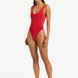 KABE SHOP INC Mara red one-piece swimsuit with a V-neckline, scoop back, and high-cut leg on a model