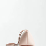 The Boulevard Sling Bag is a small, triangular-shaped sling shoulder bag in pale pink, featuring a long, thin strap and crafted from soft nappa leather, shown against a plain white background.