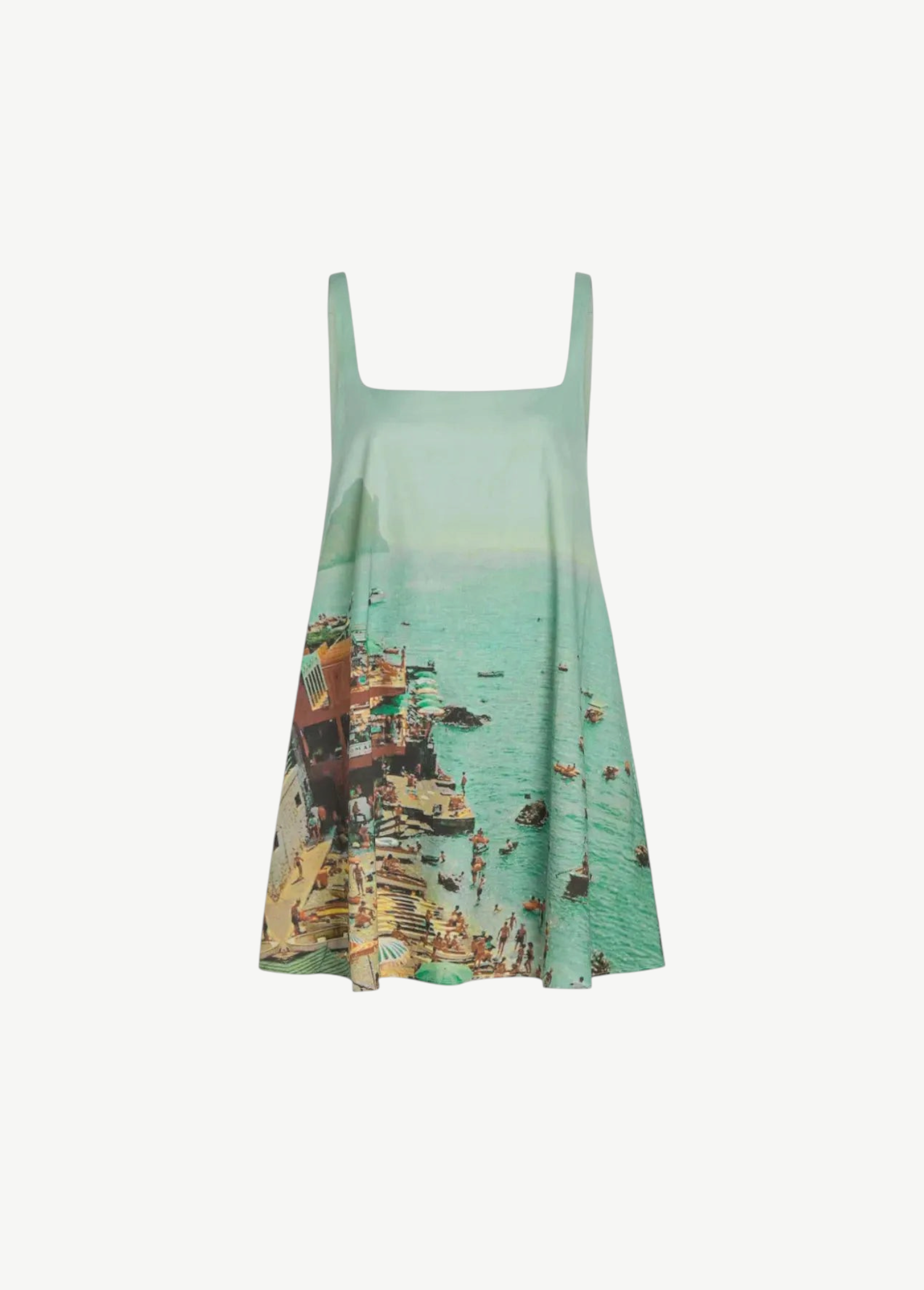 The Brio Dress is a square-neck mini dress featuring a print of a crowded beach and coastal town, designed as a versatile warm-weather essential.
