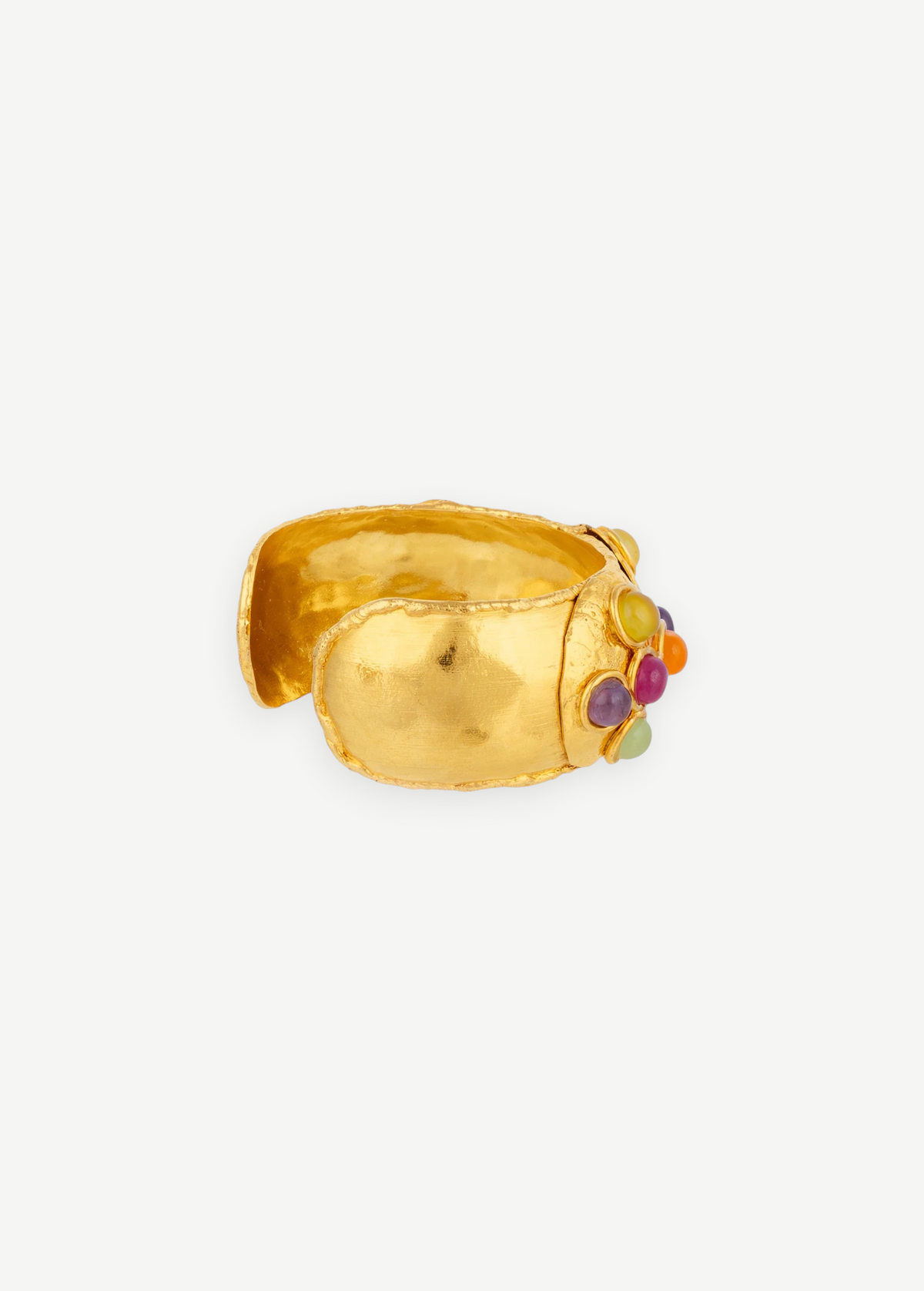 Introducing the Theodora Cuff: a wide, handcrafted gold cuff bracelet with a textured finish, adorned on one side with an eye-catching arrangement of vibrant round stones in purple, orange, yellow, and green. Effortlessly wearable, this statement piece is perfect for anyone who loves unique jewelry.