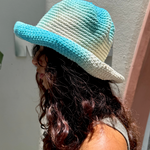 KABE SHOP INC Pora crochet hat in blue and white tie-dye worn by a woman with long wavy hair in profile view