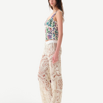 Model wearing KABE SHOP INC Cali Top with floral pattern and wide straps paired with cream lace trousers