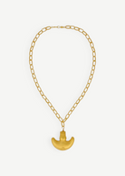 KABE SHOP INC Wanpu necklace featuring a gold anthropomorphic pendant on a thick chain inspired by Tayrona artistry.