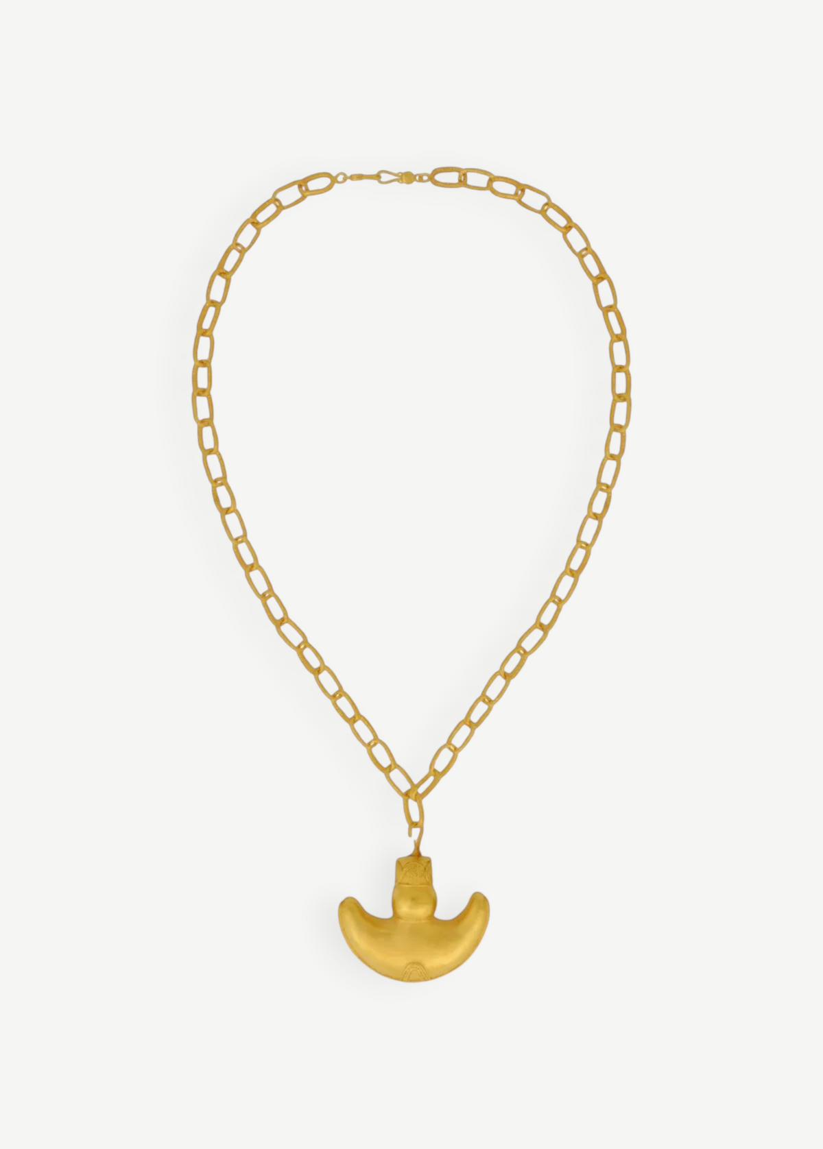 KABE SHOP INC Wanpu necklace featuring a gold anthropomorphic pendant on a thick chain inspired by Tayrona artistry.