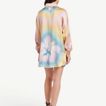 Model wearing a KABE SHOP INC Hibiscus Top in multi-colored silk with a floral print, back view.
