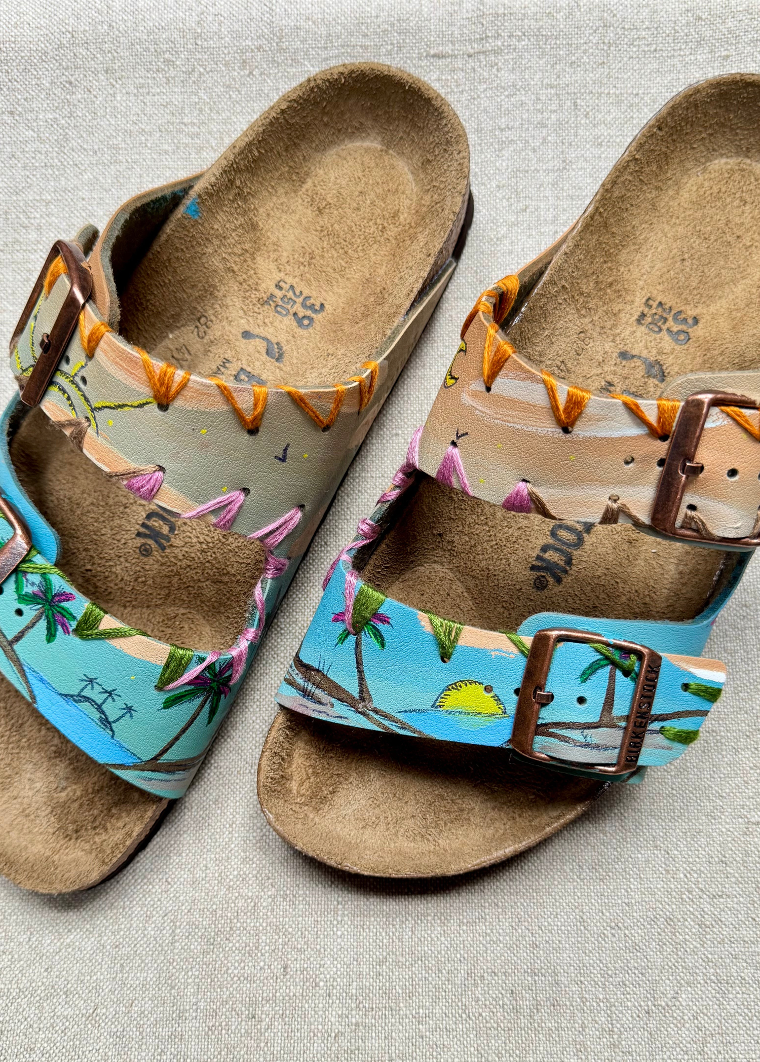KABE SHOP INC hand-painted Birkenstocks sandals featuring a tropical palm tree design and artisanal embroidery.