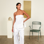 Model wearing KABE SHOP INC white strapless Sebastian Top with floral embroidery and side tie detail