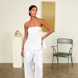 Model wearing KABE SHOP INC white strapless Sebastian Top with floral embroidery and side tie detail