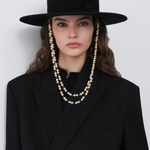 KABE SHOP INC black canotier hat with double pearl chain strap worn by a model in a black blazer