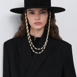 KABE SHOP INC black canotier hat with double pearl chain strap worn by a model in a black blazer