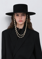 KABE SHOP INC black canotier hat with double pearl chain strap worn by a model in a black blazer