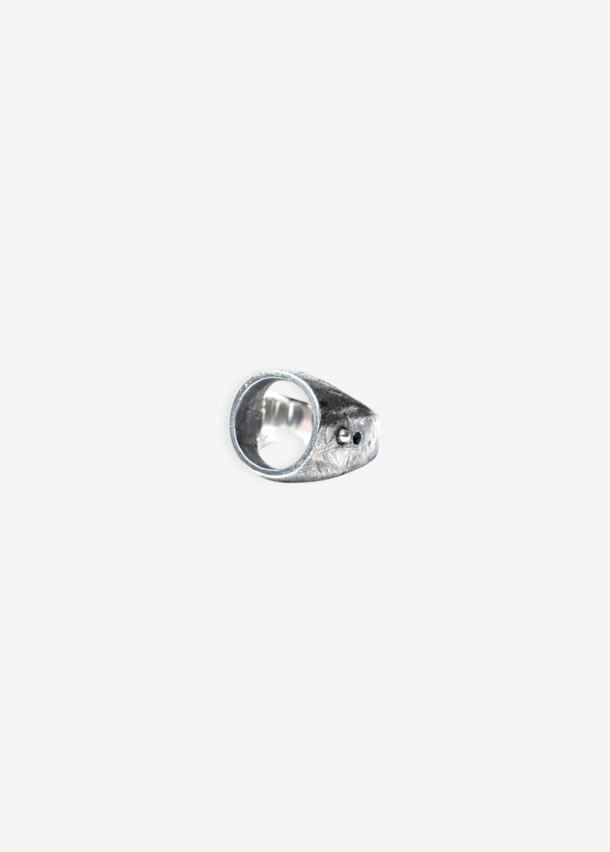 KABE SHOP INC Cricket ring in textured sterling silver with a unique circular design and small stud detail
