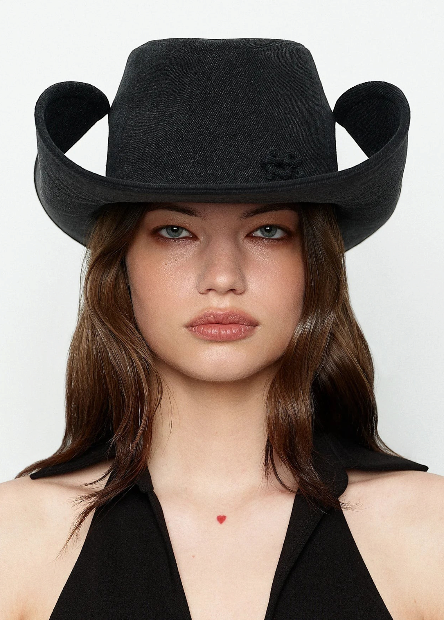 KABE SHOP INC black denim cowboy hat with a structured, wide-brimmed silhouette worn by a woman