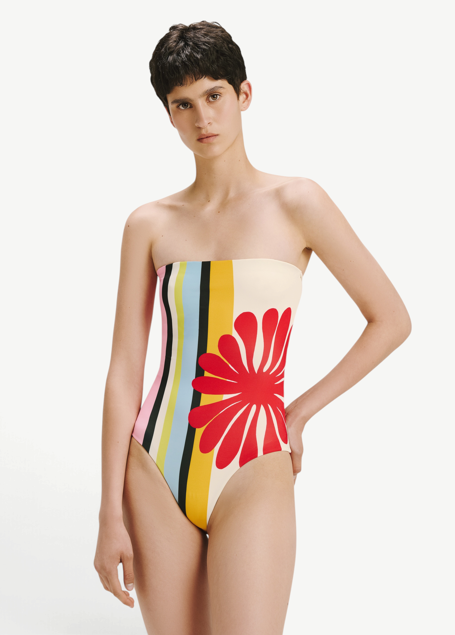 KABE SHOP INC Ulla one-piece swimsuit featuring a multi-colored vertical stripe pattern and a large red floral motif.