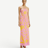 Model wearing a KABE SHOP INC Daphne strapless pink maxi dress with yellow floral print and ruched side detailing