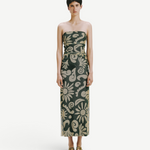 Model wearing KABE SHOP INC Daphne dress, a strapless midi length piece with a dark green and beige floral pattern.