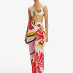 Model wearing KABE SHOP INC Luana Sarong in a vibrant multi-colored floral and striped print over matching bikini