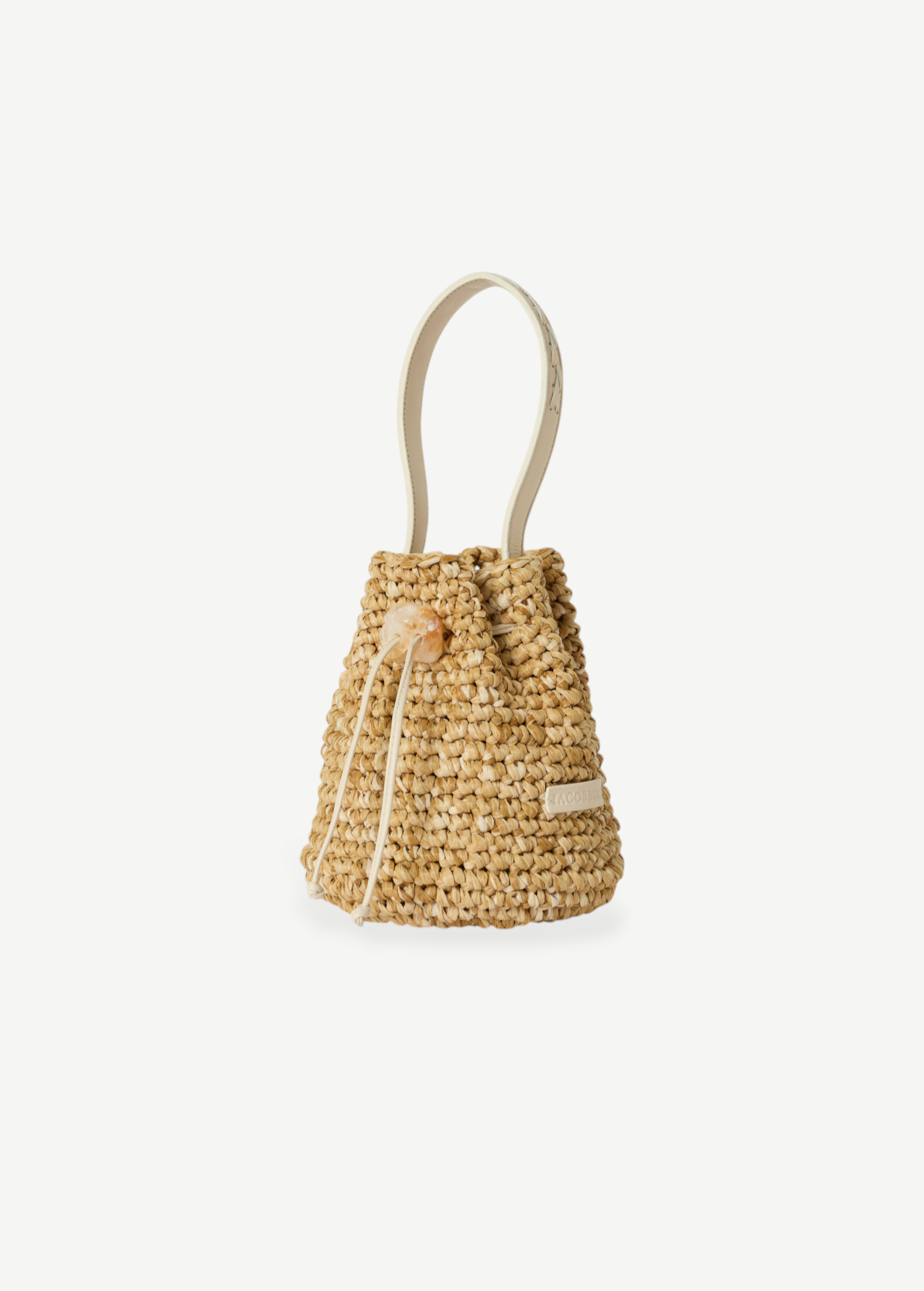 KABE SHOP INC Nirmala bucket bag in woven raffia with a leather handle and a unique crystal drawstring closure.