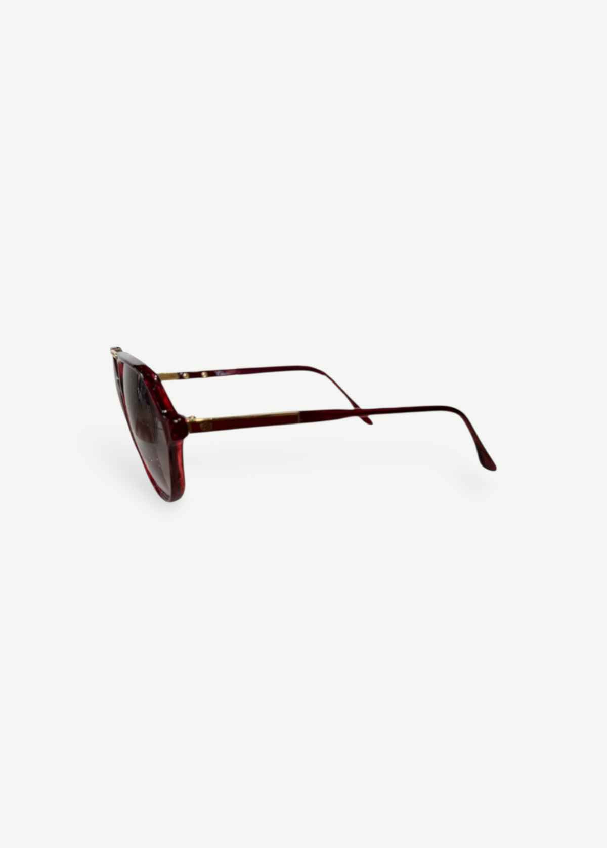KABE SHOP INC Christopher D sunglasses featuring a deep red translucent frame and gold metal accents, side view.