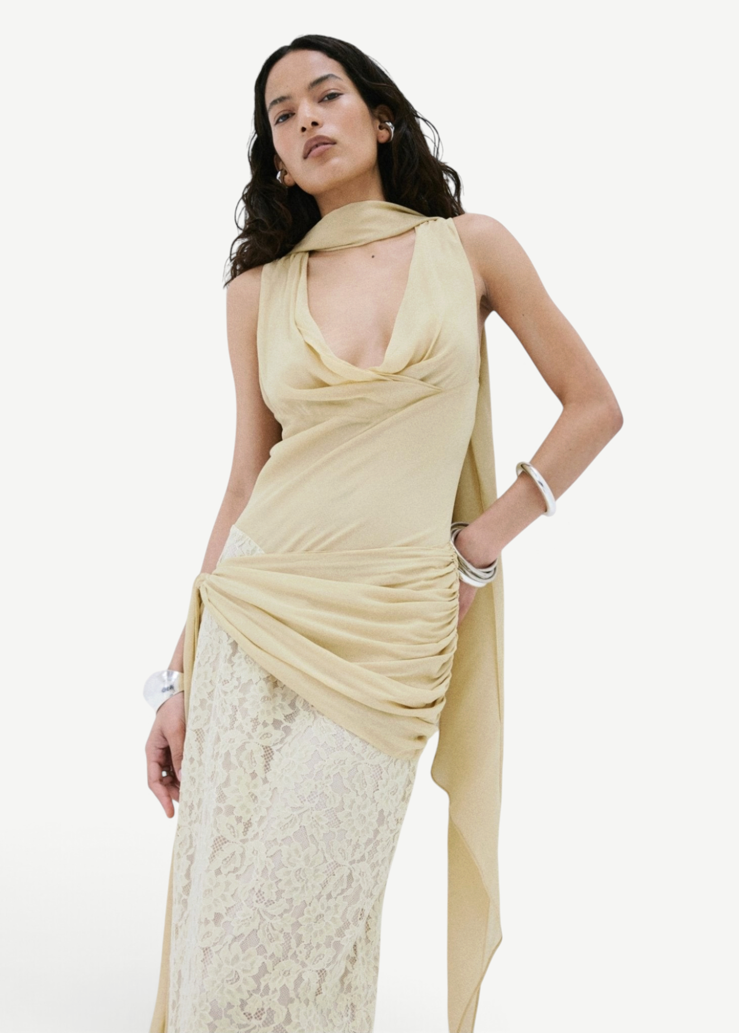 Model wearing KABE SHOP INC Rosa maxi dress in antique yellow viscose georgette with delicate lace skirt detailing.
