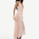 Model wearing KABE SHOP INC Balia midi dress in baby pink floral viscose georgette with ruffled asymmetric hem