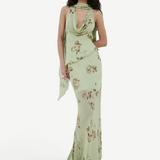 A person wears the sage green, floor-length georgette Diosa Skirt with a cowl neckline, brown floral print, and an asymmetric hem.