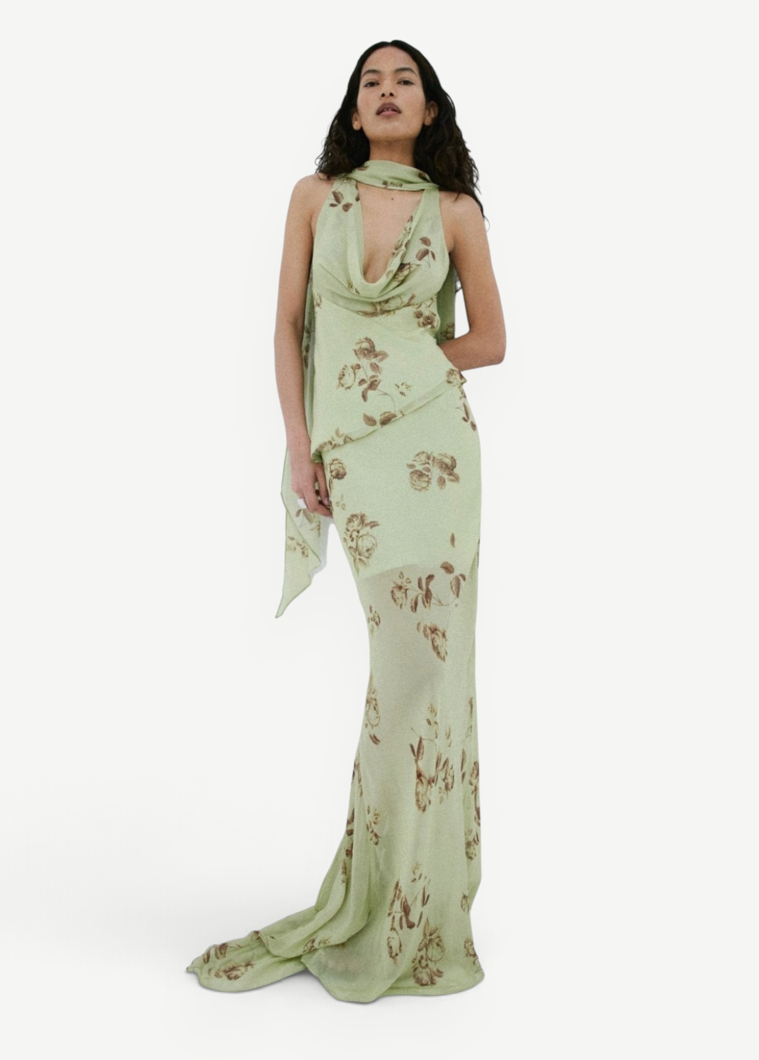 A person wears the sage green, floor-length georgette Diosa Skirt with a cowl neckline, brown floral print, and an asymmetric hem.