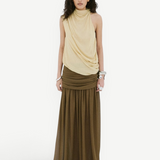 A person wears a beige sleeveless draped top and an Agapito Skirt in dark olive taupe chiffon, creating an elongated silhouette.
