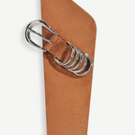KABE SHOP INC Alcott suede belt in tan with asymmetrical shape and signature silver five-ring hardware detail.