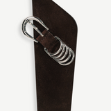 KABE SHOP INC Alcott suede belt in dark brown featuring an asymmetrical shape and silver-tone five-ring hardware.