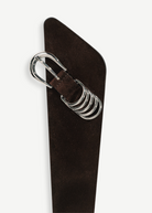 KABE SHOP INC Alcott suede belt in dark brown featuring an asymmetrical shape and silver-tone five-ring hardware.
