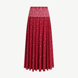 The Rylie Skirt is a red midi skirt with a white paisley print waistband and a small white floral pattern throughout its red bandana print design.