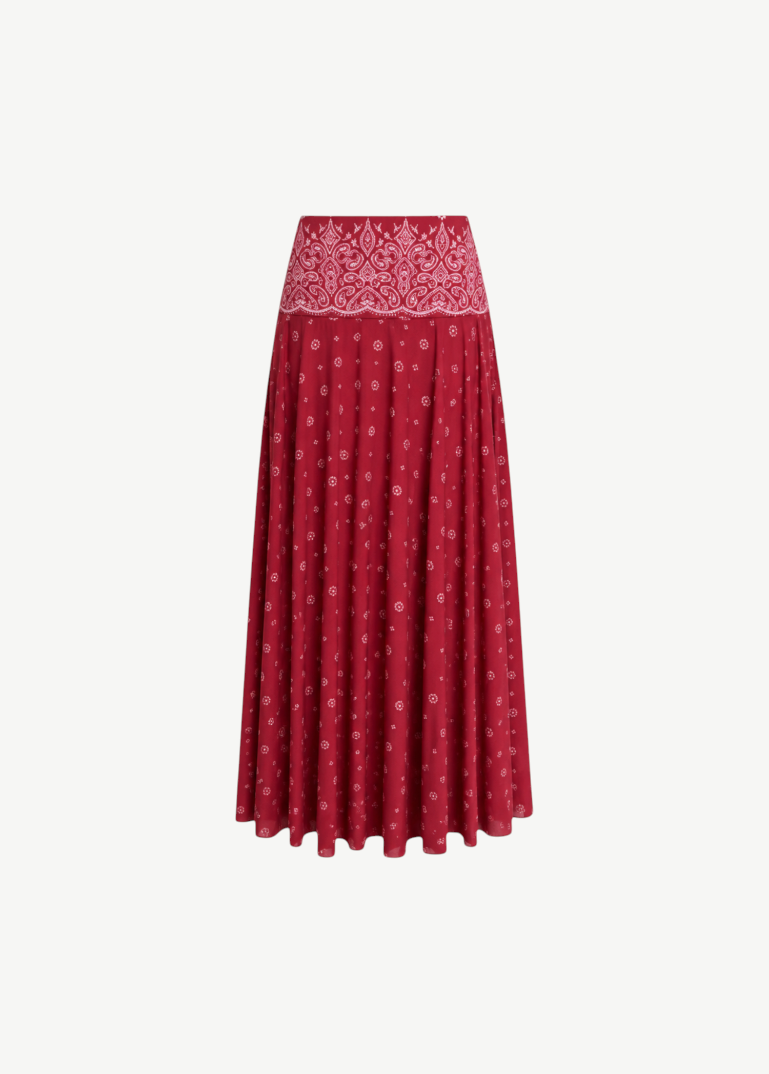 The Rylie Skirt is a red midi skirt with a white paisley print waistband and a small white floral pattern throughout its red bandana print design.